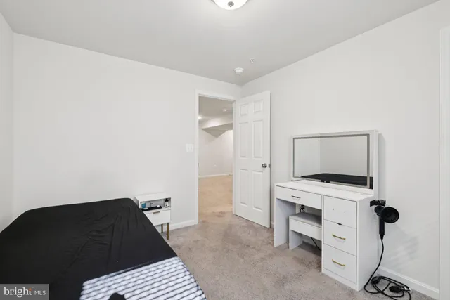 a living room with a bed and a flat screen tv