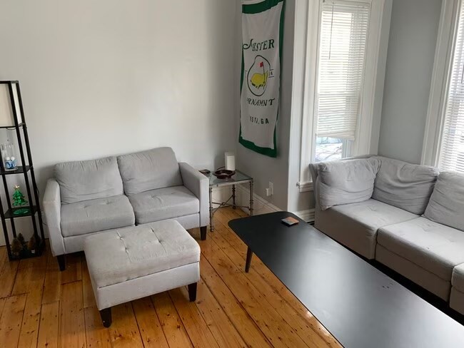 153 Chestnut Street, Unit 1 Waltham, MA 02453 - Photo 5 of 10 a living room with furniture and a window