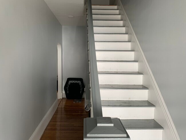 153 Chestnut Street, Unit 1 Waltham, MA 02453 - Photo 8 of 10 a view of a hallway with wooden floor and windows