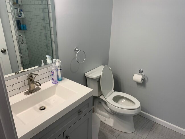 153 Chestnut Street, Unit 1 Waltham, MA 02453 - Photo 9 of 10 a bathroom with a toilet sink and mirror