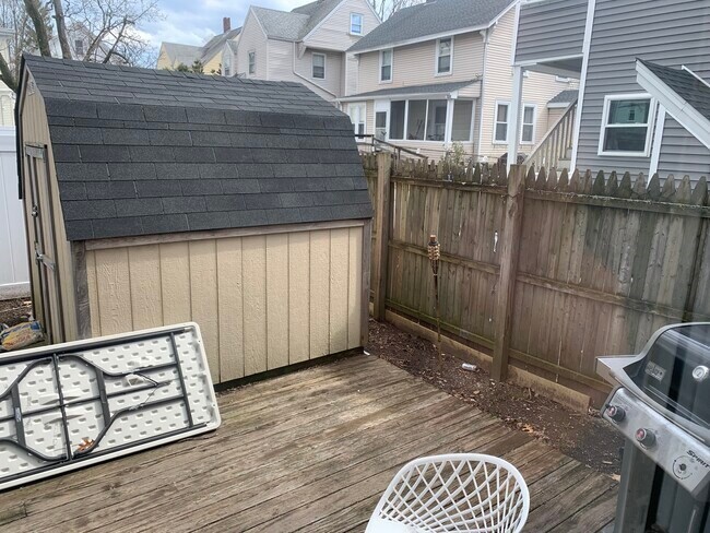 153 Chestnut Street, Unit 1 Waltham, MA 02453 - Photo 10 of 10 a backyard of a house with wooden floor