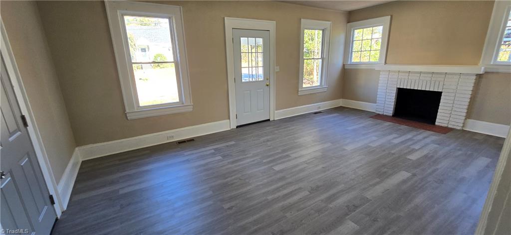 113 Edgeworth Street High Point, NC 27262 - Photo 5 of 24 Large living room with wide moldings. Seller has never used fireplace.