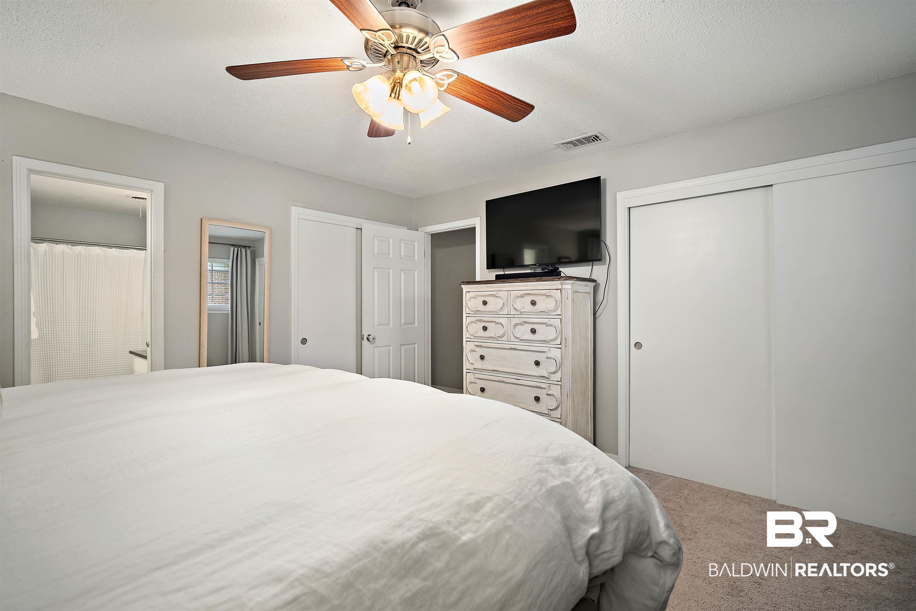 4228 Spring Valley Drive South Mobile, AL 36693 - Photo 17 of 31 Bedroom featuring ceiling fan, carpet, and a textured ceiling