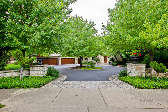 a front view of a house with a yard and a garden