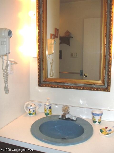 18 Cherry Ridge Road Bushkill, PA 18324 - Photo 15 of 16 a bathroom with a sink and a mirror