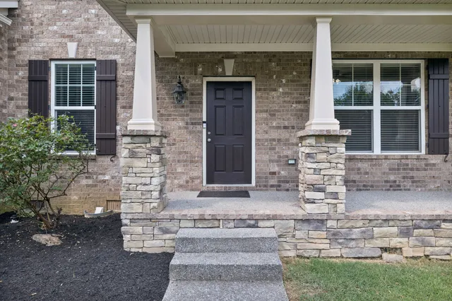 front view of a brick house with a large windows