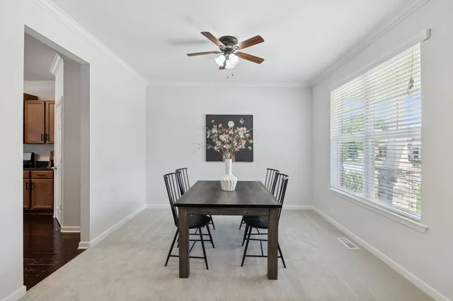 a dining room with furniture and window