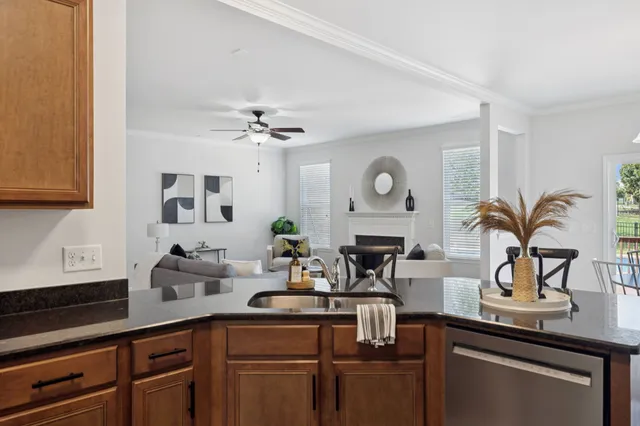a kitchen with stainless steel appliances a stove sink microwave and cabinets