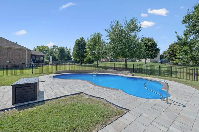 a view of a swimming pool with a lounge chair