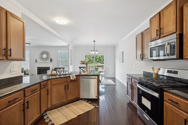 a kitchen with stainless steel appliances a stove sink microwave and cabinets