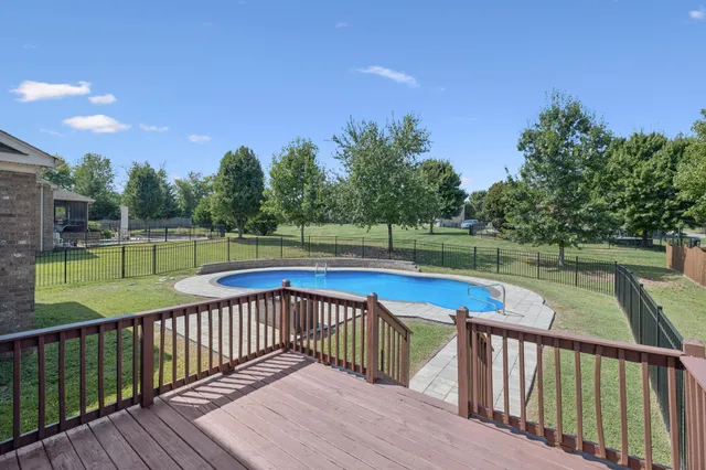 a balcony with wooden floor and outdoor space