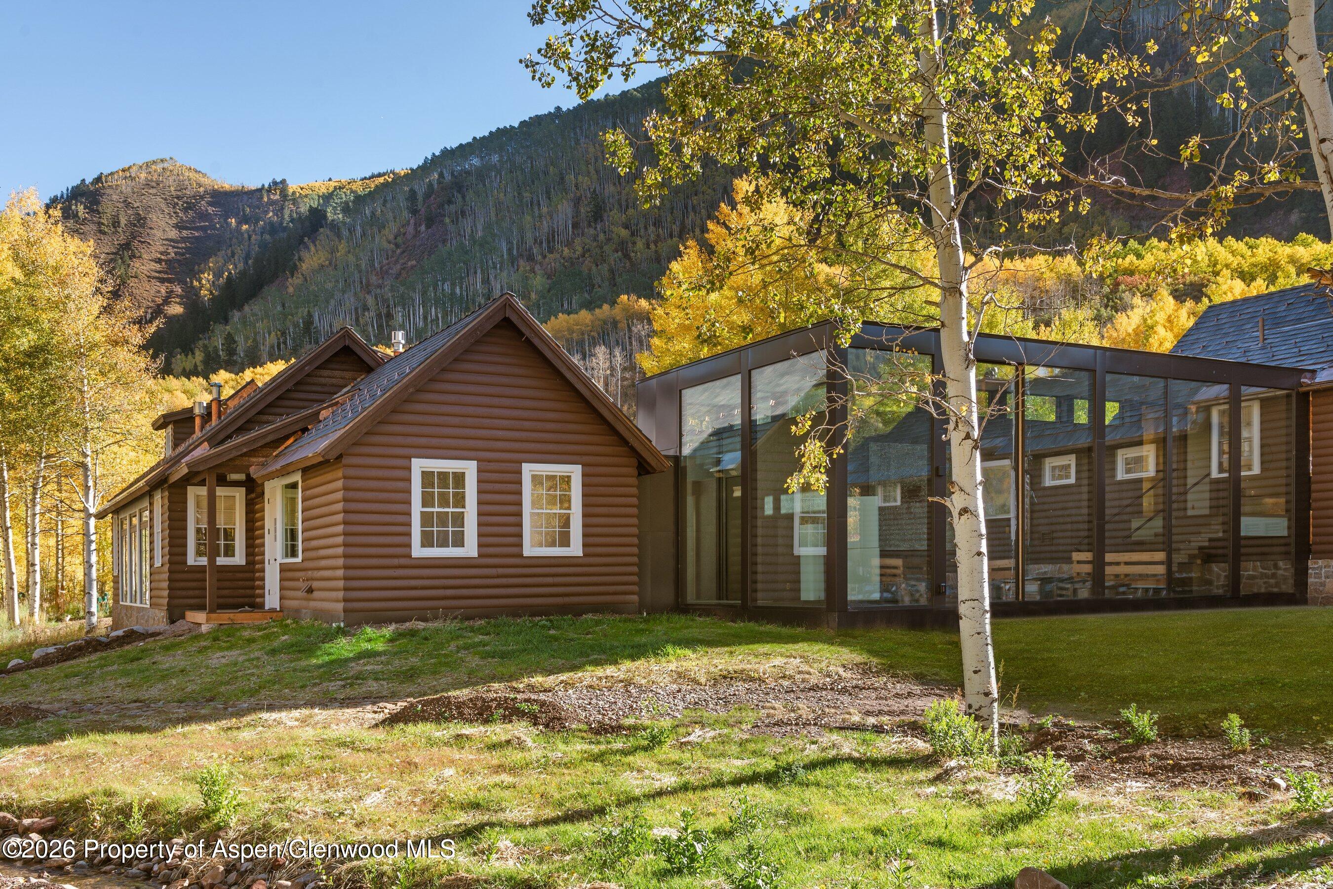 5387 Castle Creek Road Aspen, CO 81612 - Photo 3 of 20 a house that has a tree in front of it