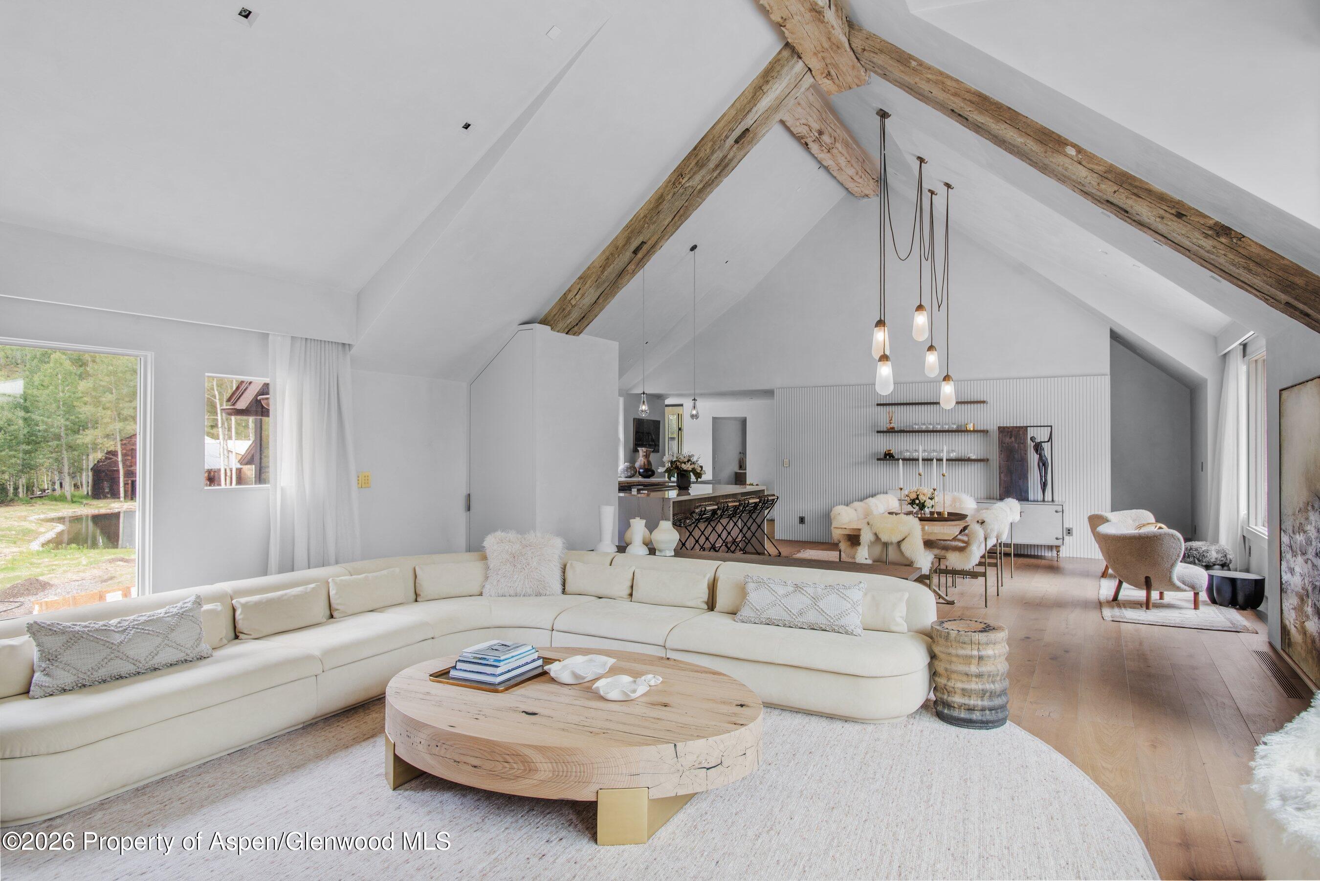 5387 Castle Creek Road Aspen, CO 81612 - Photo 4 of 20 a living room with furniture white walls and a chandelier