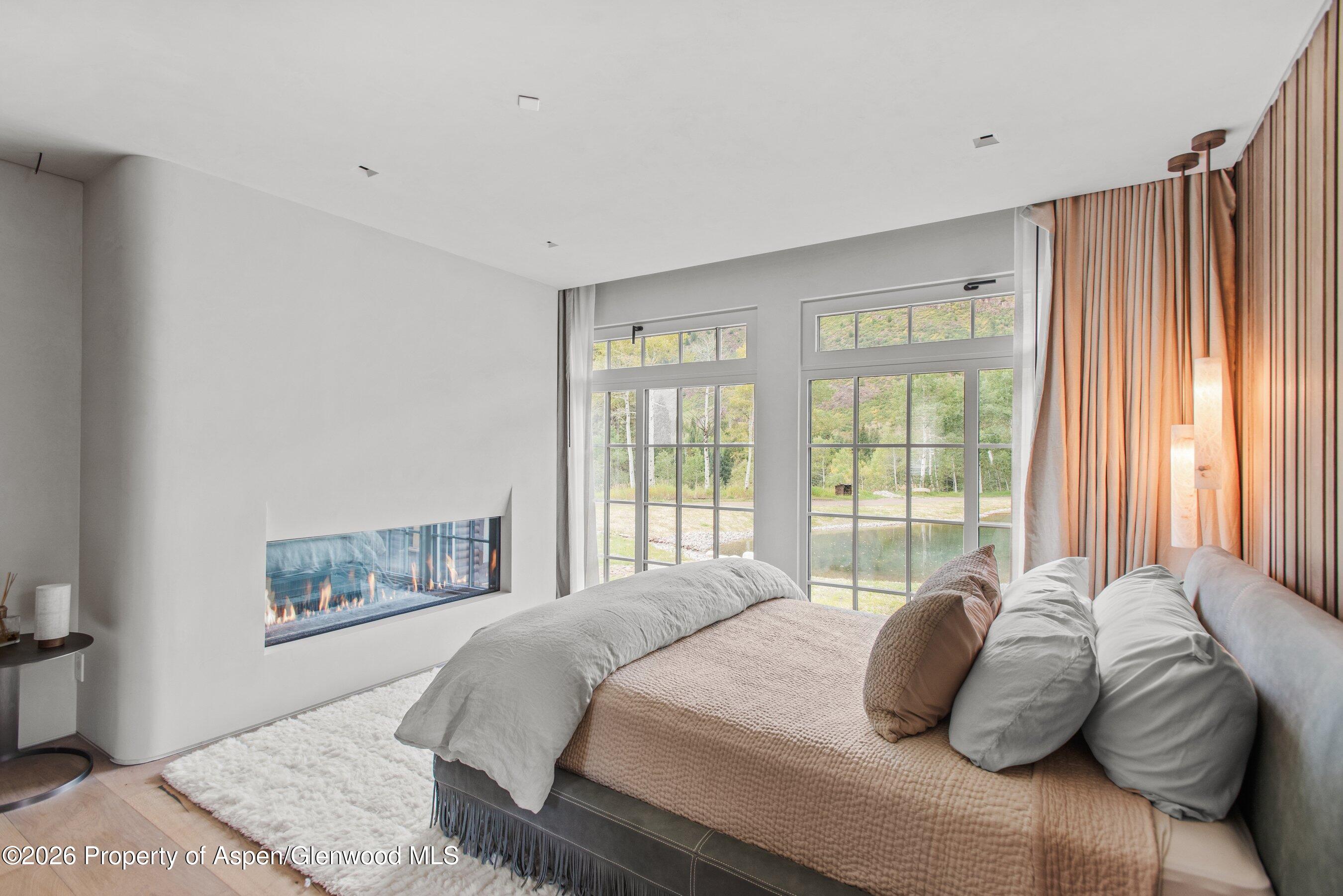 5387 Castle Creek Road Aspen, CO 81612 - Photo 8 of 20 a bedroom with a bed and a window