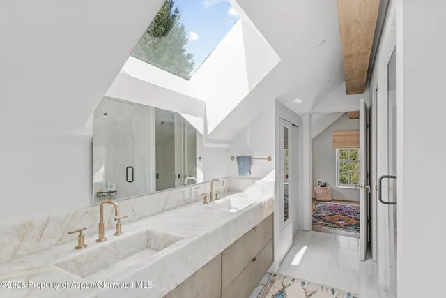 a living room with furniture a rug and a window