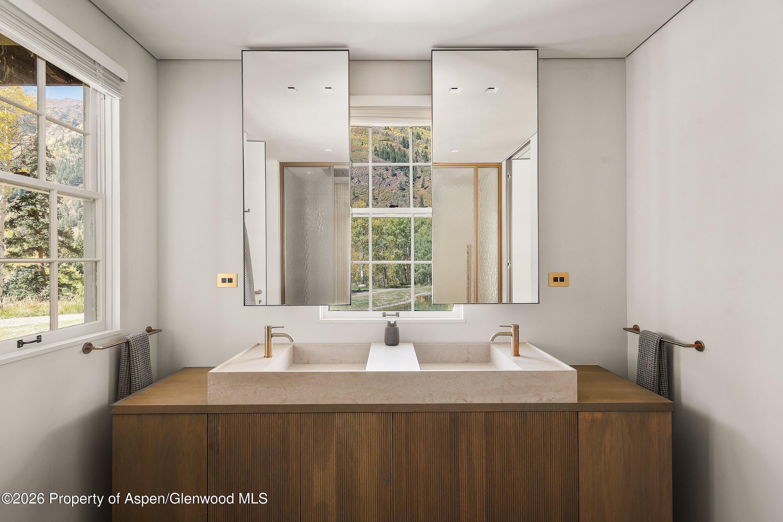 5387 Castle Creek Road Aspen, CO 81612 - Photo 10 of 20 a bathroom with a granite countertop sink and a window
