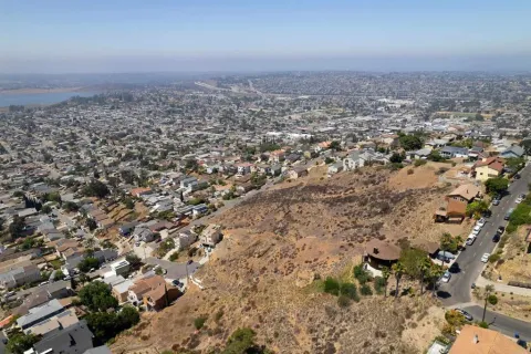 an aerial view of a house with a yard