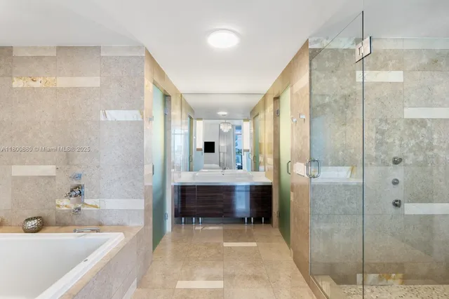 a spacious bathroom with a tub shower and sink