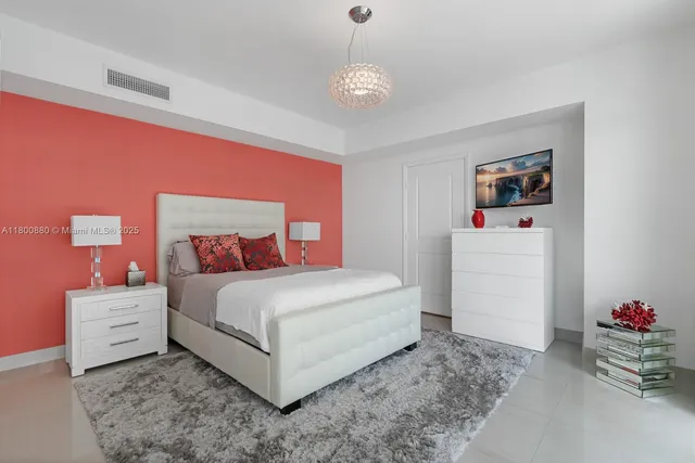 a bedroom with a bed and cabinets