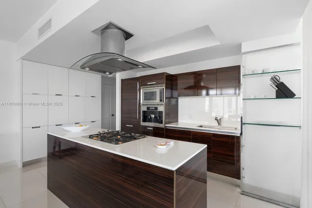 a kitchen with a sink refrigerator and cabinets