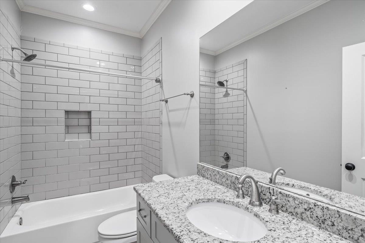 9074 Baynard Loop North Germantown, TN 38139 - Photo 19 of 36 a bathroom with a granite countertop bathtub sink vanity mirror and toilet