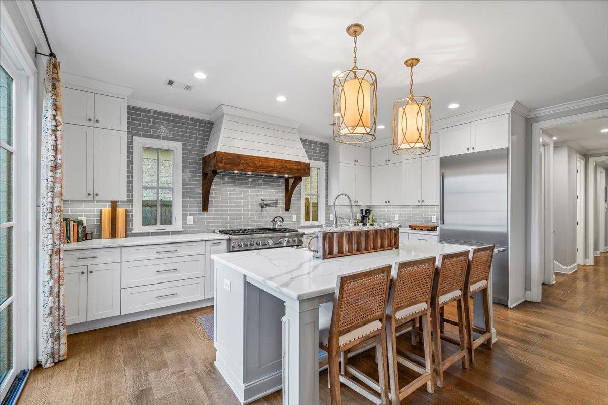9074 Baynard Loop North Germantown, TN 38139 - Photo 8 of 36 a kitchen with stainless steel appliances kitchen island granite countertop a table chairs in it and wooden floors