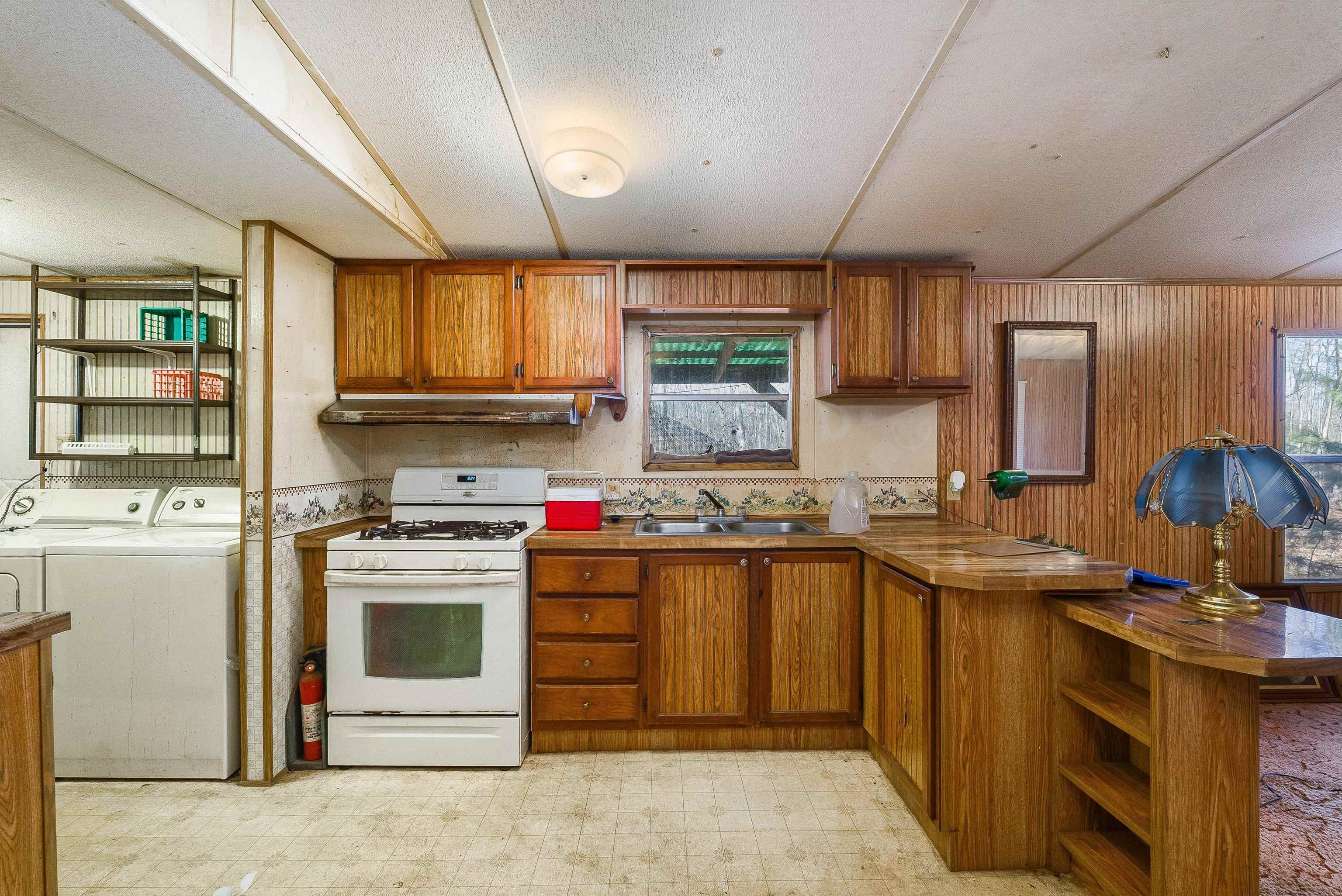 2851 Thoroughfare Road Elkton, VA 22827 - Photo 11 of 41 a kitchen with stainless steel appliances granite countertop a stove sink and cabinets