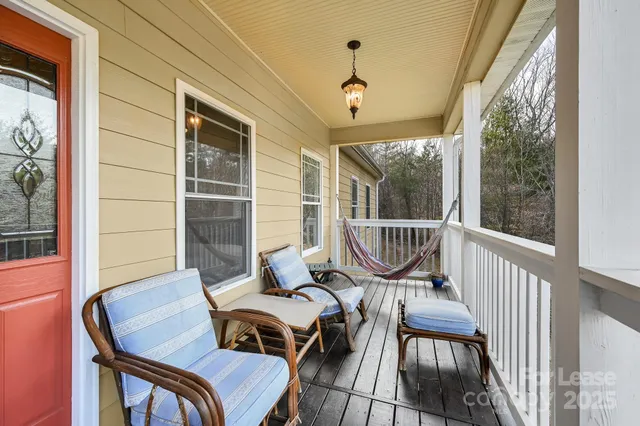 a view of a couches chair and fire pit in the balcony