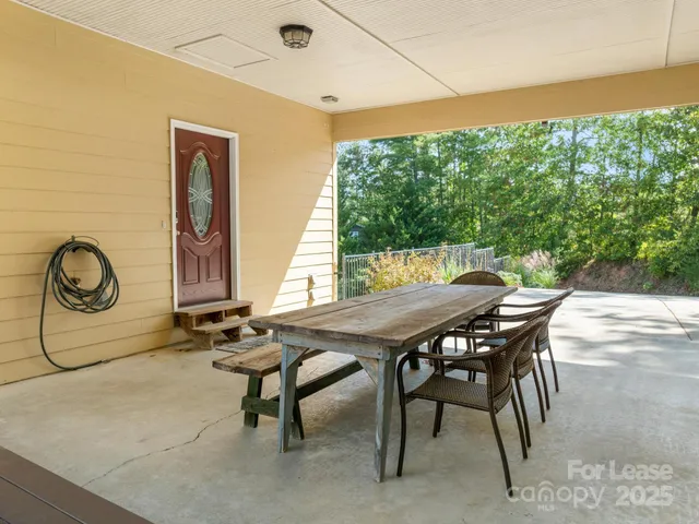 a kitchen with a table chairs stove and kitchen view