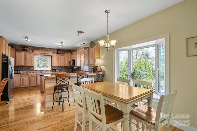 a kitchen with stainless steel appliances granite countertop sink stove top oven and cabinets