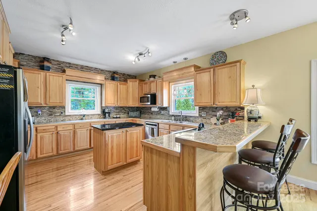 a kitchen with stainless steel appliances a stove sink and refrigerator
