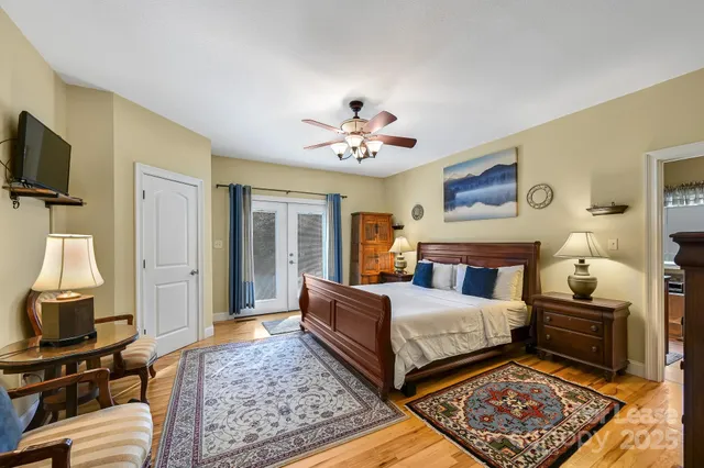 a bedroom with furniture and a large mirror