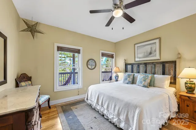 a bedroom with a bed lamp and a window