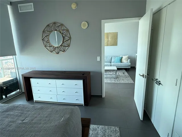 a view of a hallway to a livingroom with furniture