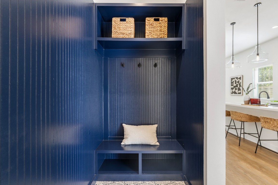 1215 Sampson Street Houston, TX 77003 - Photo 16 of 35 The elegantly designed mudroom with wainscoting, a bench, and cubbies offers practical yet stylish storage solutions. Located at the home's entryway.