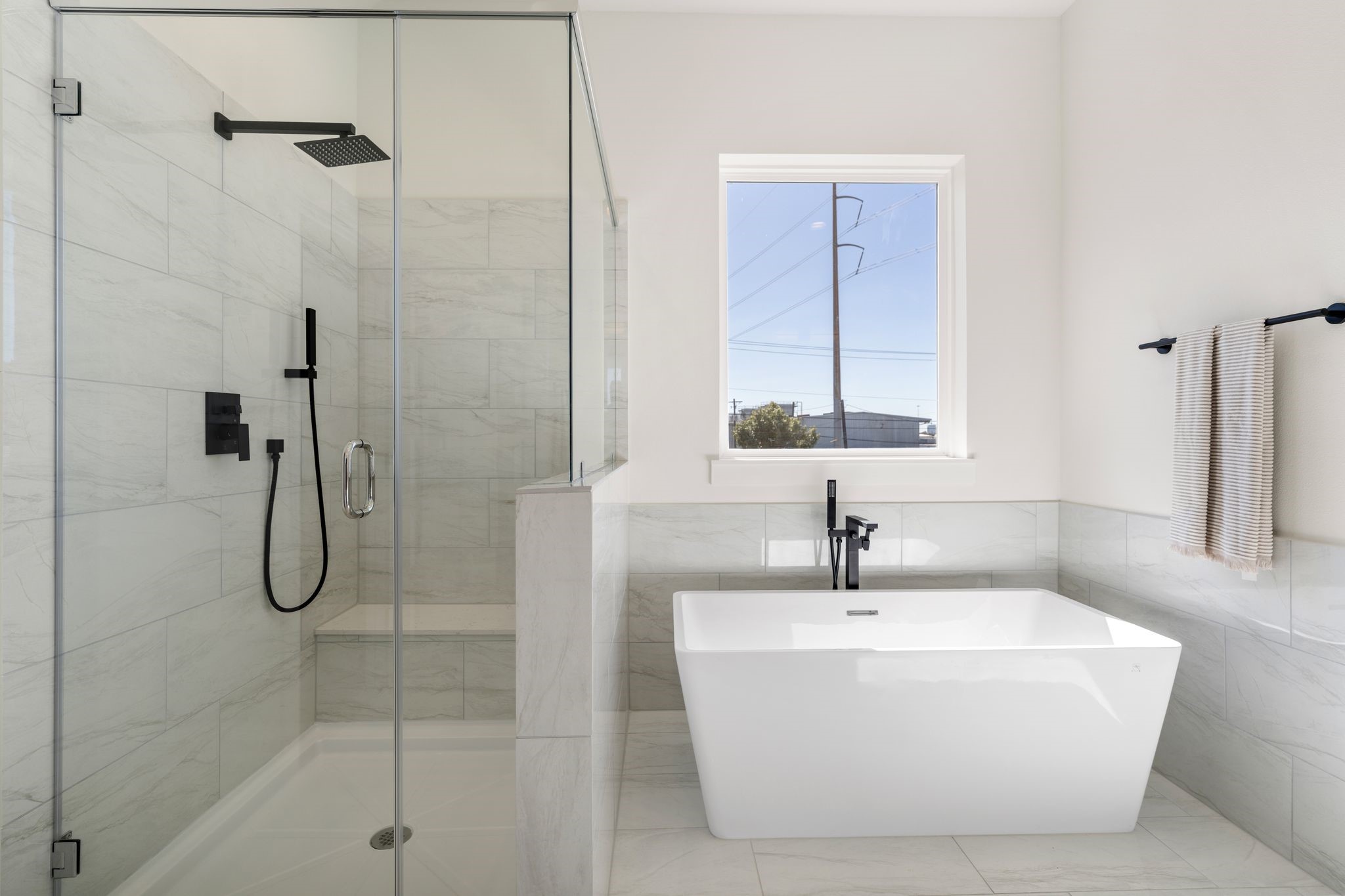 1215 Sampson Street Houston, TX 77003 - Photo 20 of 35 A closer look at the grand soaking bathtub with standing tub filler and sprayer, semi-frameless walk-in shower with a rain shower head.