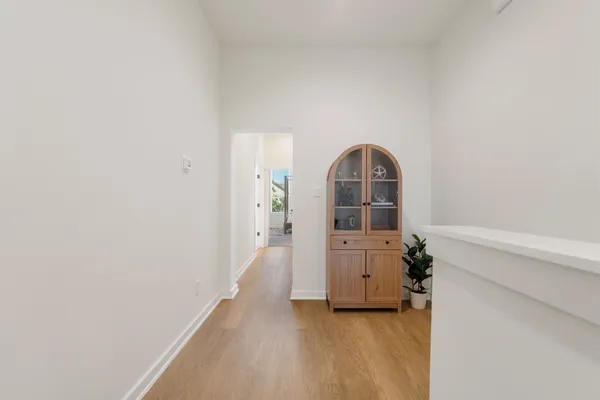 a view of a room with wooden floor and cabinet