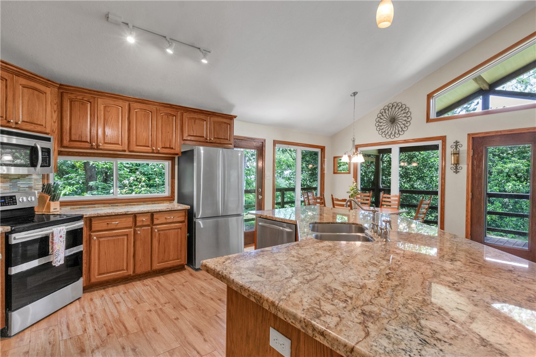 9997 Calhoun Road Bryan, TX 77808 - Photo 6 of 50 a large kitchen with kitchen island a large window in it