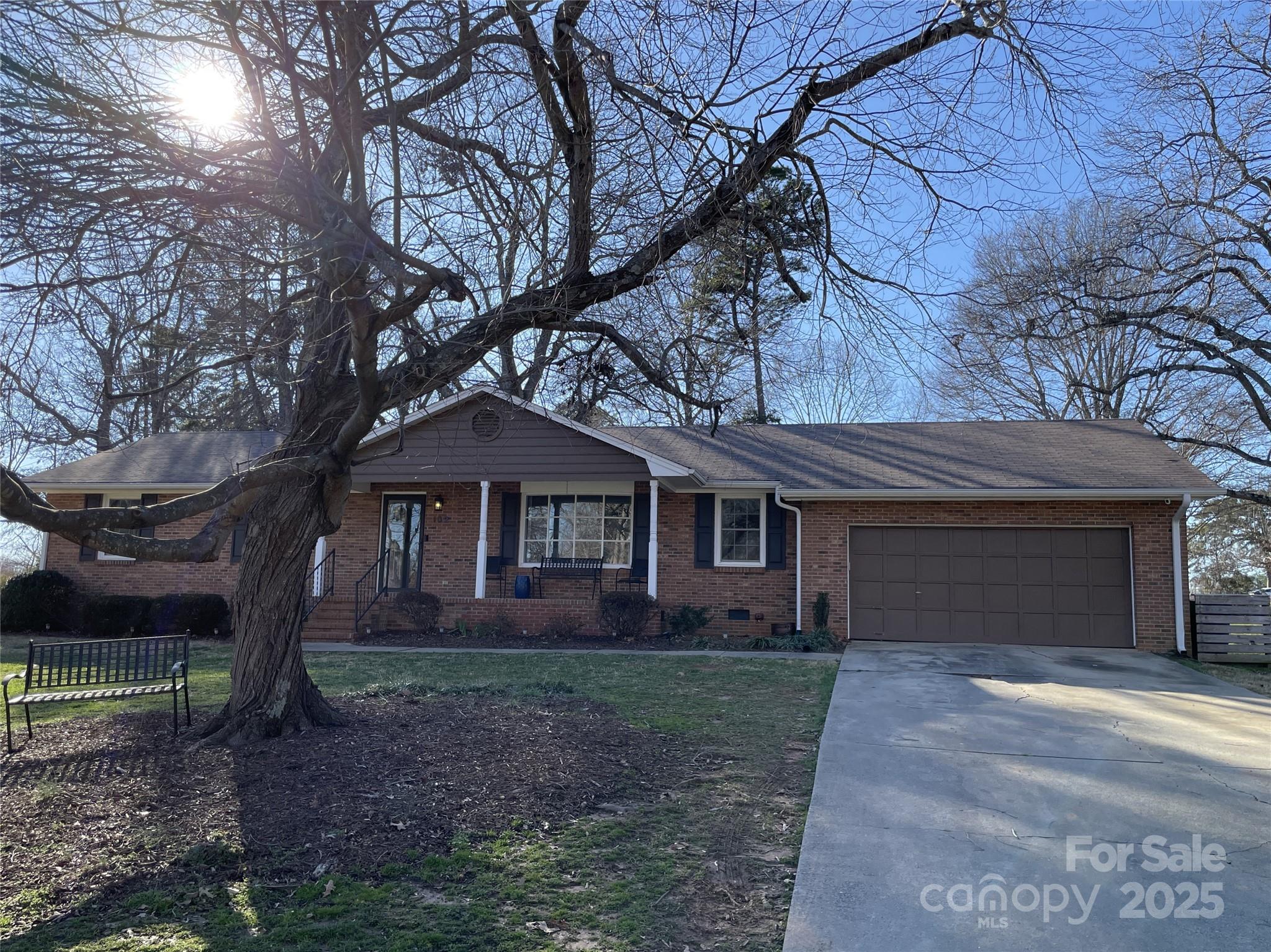 a front view of a house with yard and trees
