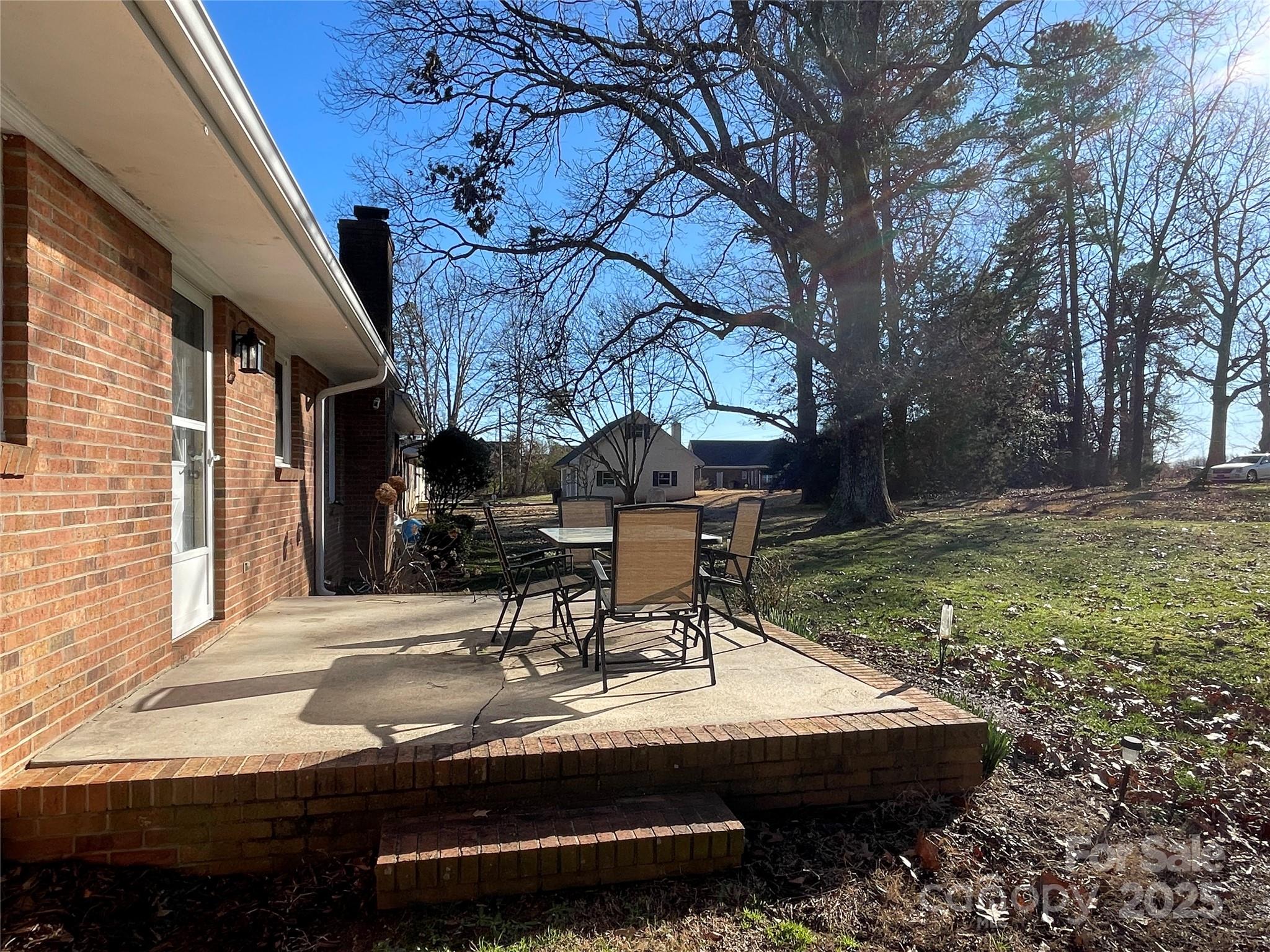 102 General Bragg Street Stanley, NC 28164 - Photo 7 of 31 a view of patio with table and chairs and potted plants