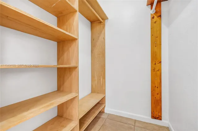 a view of an empty room with closet