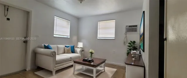 a living room with furniture and a potted plant