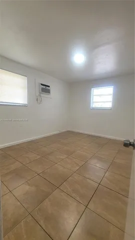 an empty room with a empty space and windows