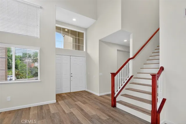 a view of entryway with wooden floor and stairs