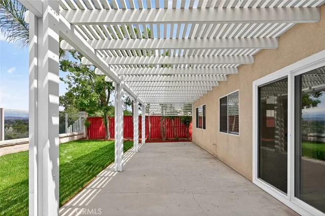 a view of a porch with a table and chairs