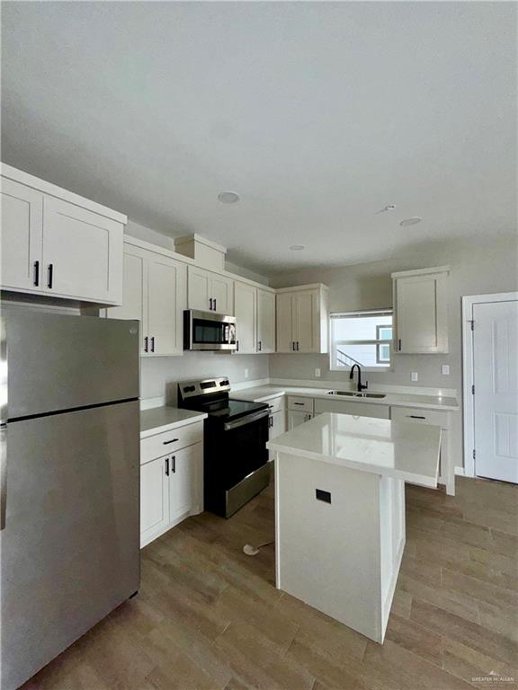 716 Ragland Road, Unit 3 Mission, TX 78572 - Photo 7 of 7 a kitchen with white cabinets and white appliances
