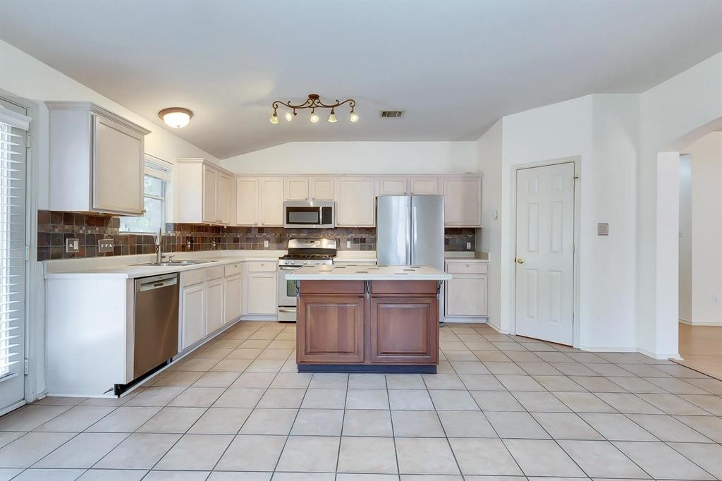 3337 Cantera Way Round Rock, TX 78681 - Photo 11 of 25 a kitchen with stainless steel appliances granite countertop a refrigerator sink and cabinets