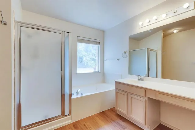 a bathroom with a tub shower and sink