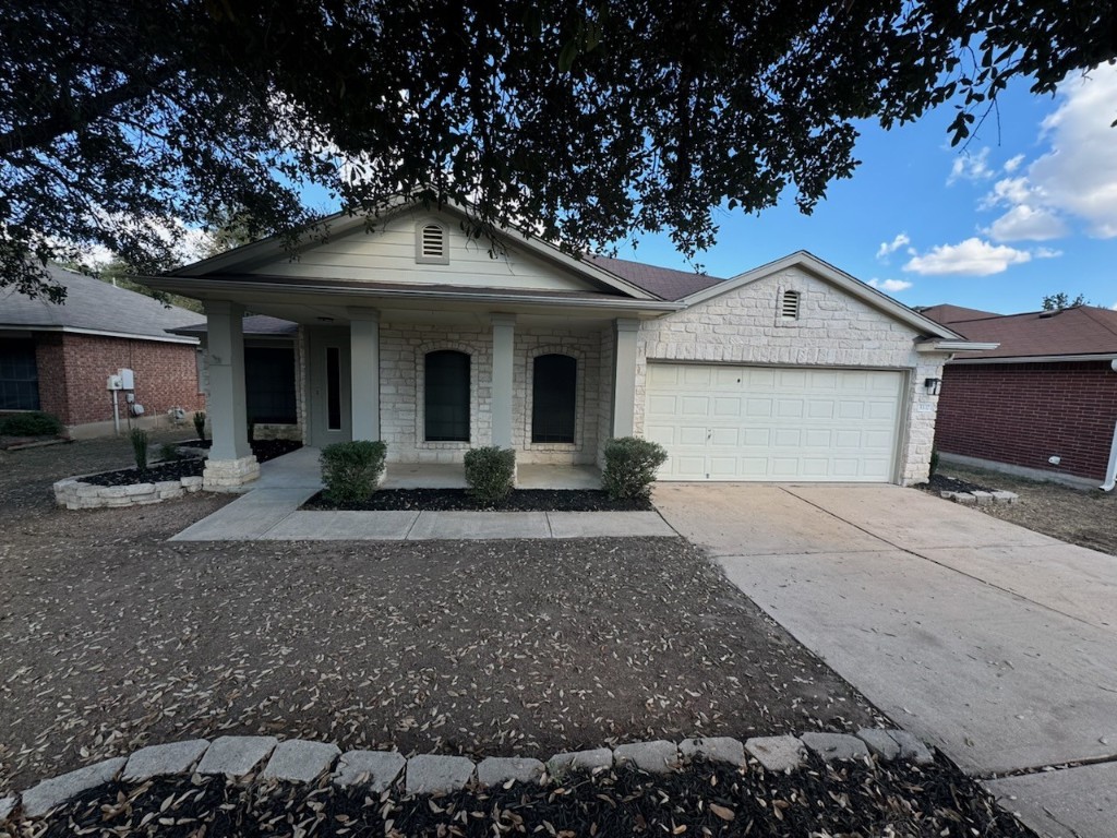 3337 Cantera Way Round Rock, TX 78681 - Photo 3 of 25 a front view of a house with garden