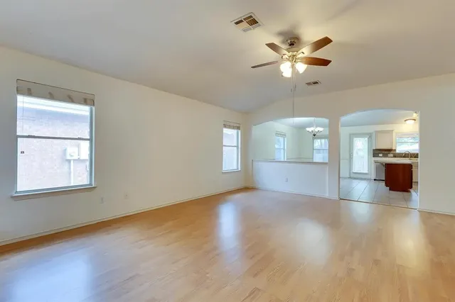 a view of a livingroom with a ceiling fan and wooden floor